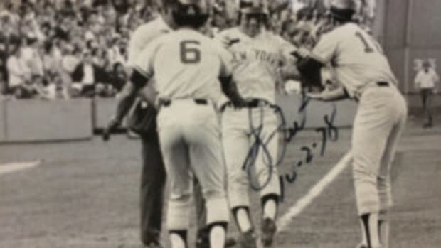  Bucky Dent autographed photos of his famous Oct. 2, 1978 home run during a visit to the Prospect Center for developmentally disabled persons in Queensbury, N.Y. In the photo Dent reaches home plate as Yankees teammates Roy White and Chris Chambliss look on. White and Chambliss were on base for the home run that gave the Yankees a 3-2 lead in a game that clinched the American League East title.