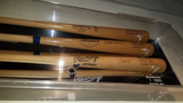  Autographed bats from former major leaguers are displayed in a display case at Champions Sports Bar in Puerto Vallarta in Mexico.
