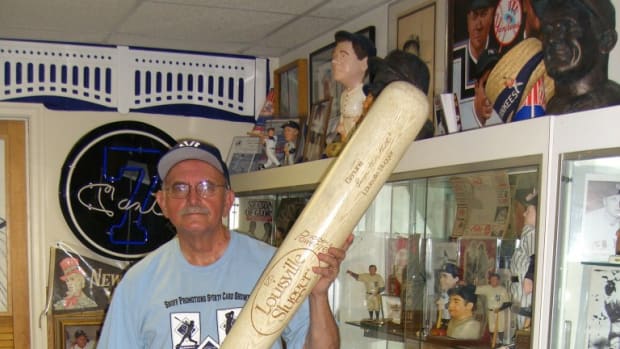 Nick Shoff poses among a section of his Yankee collection.