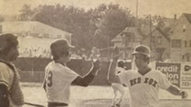 Marty Barrett scores the winning run in the continuation of the 33-inning game on June 23, 1981. He is being congratulated at home plate by Wade Boggs.