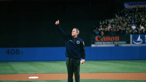 President George W. Bush gives a thumbs-up before throwing out the first pitch prior to Game 3 of the 2001 World Series at Yankee Stadium.