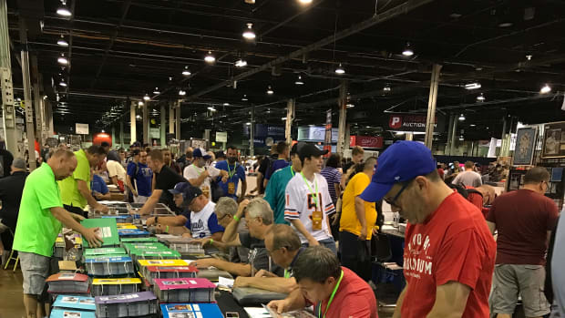 Collectors look through vintage cards at the Uncle Dick's Cards booth at The National.