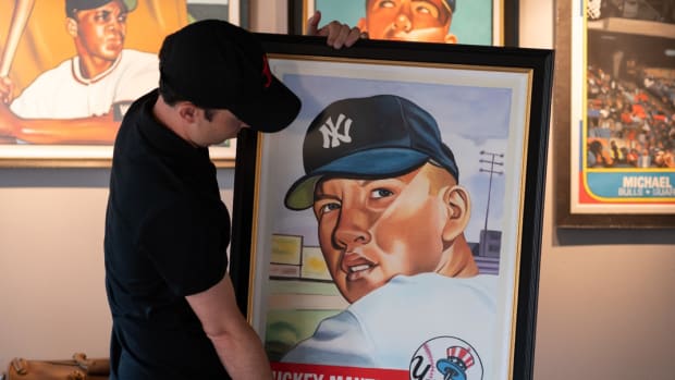 Artist James Fiorentino shows off his painting of a 1953 Mickey Mantle card.