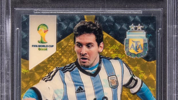 2014 Panini Prizm World Cup Gold Power Prizm Lionel Messi card.