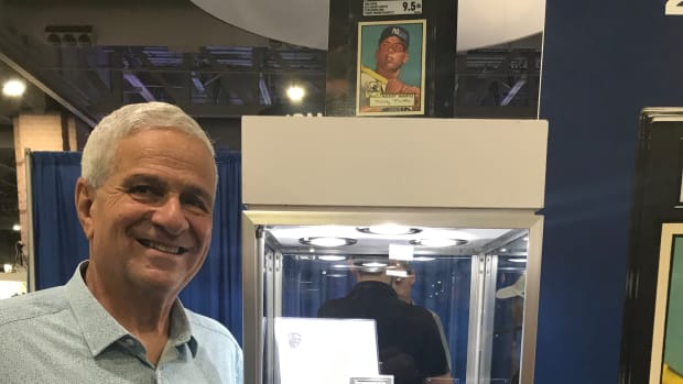 Collector Anthony Giordano poses with his Topps 1952 Mickey Mantle card that is expected to set the sports card record.
