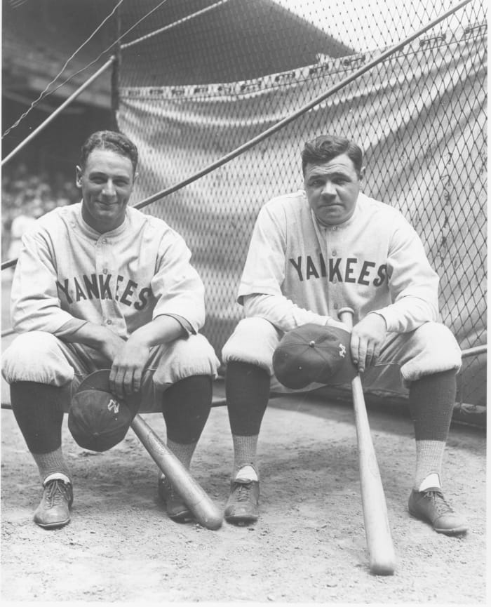 Lou Gehrig and Babe Ruth sit by the batting cage at League Park in Clevelan...