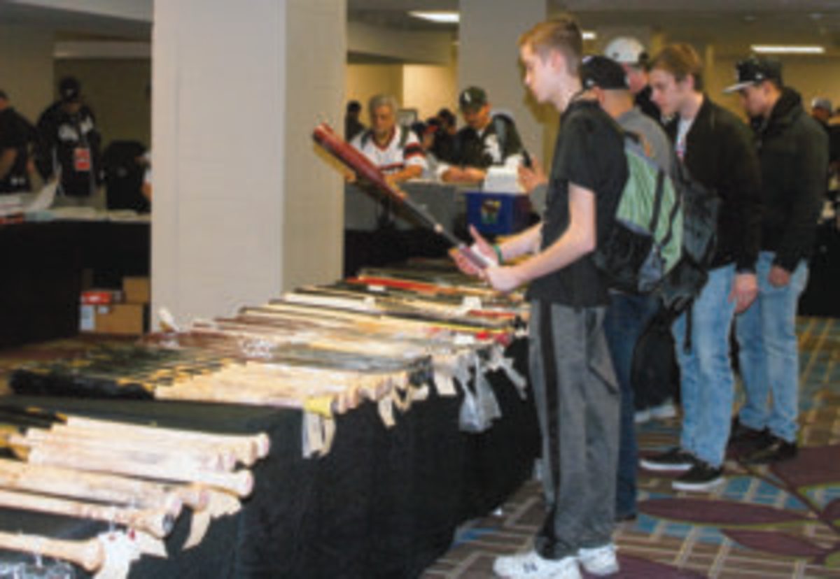  Fans and collectors look through the many game-used bats at the Garage Sale at SoxFest 2019.