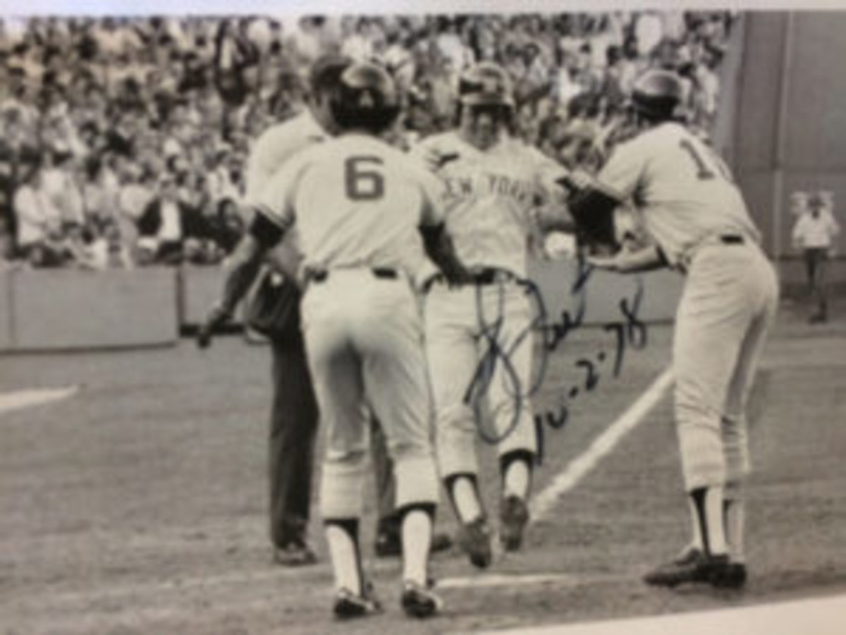  Bucky Dent autographed photos of his famous Oct. 2, 1978 home run during a visit to the Prospect Center for developmentally disabled persons in Queensbury, N.Y. In the photo Dent reaches home plate as Yankees teammates Roy White and Chris Chambliss look on. White and Chambliss were on base for the home run that gave the Yankees a 3-2 lead in a game that clinched the American League East title.