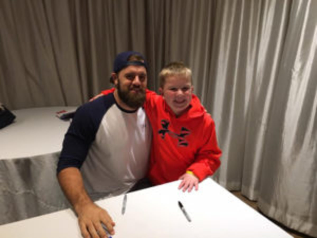  Autograph signer James Develin of the New England Patriots with Charlie Keating, the 8-year-old son of show promoter Doug Keating.