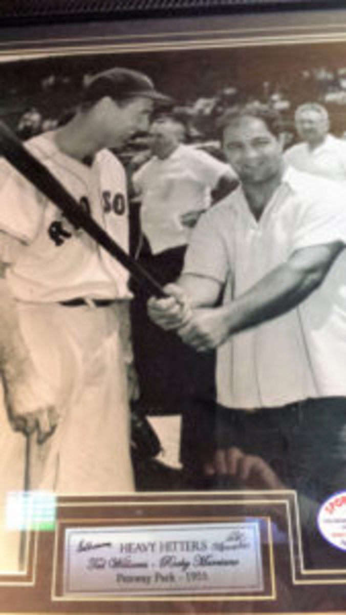  A framed photo featuring Ted Williams and Rocky Marciano, dated 1955.