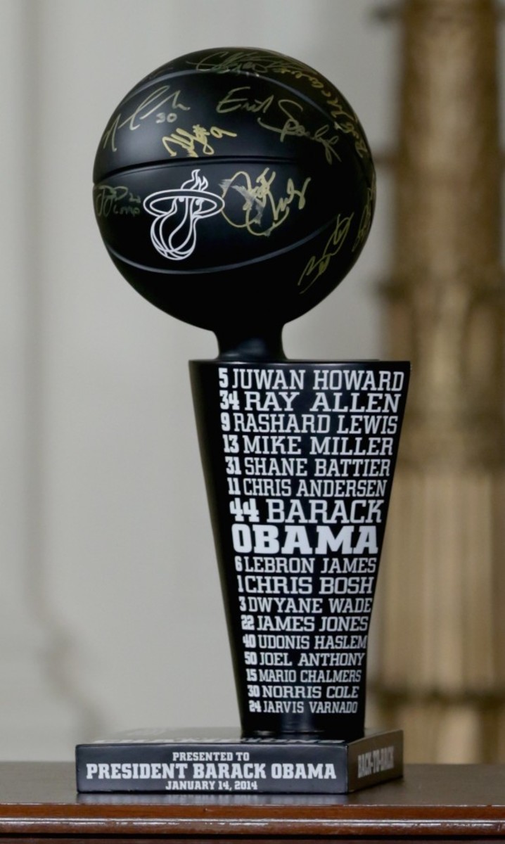 The Miami Heat provided a replica NBA championship Trophy to President Obama, signed by the entire team and full of notches representing the team’s playoff wins. Photo By Chip Somodevilla NBAE-Getty Images