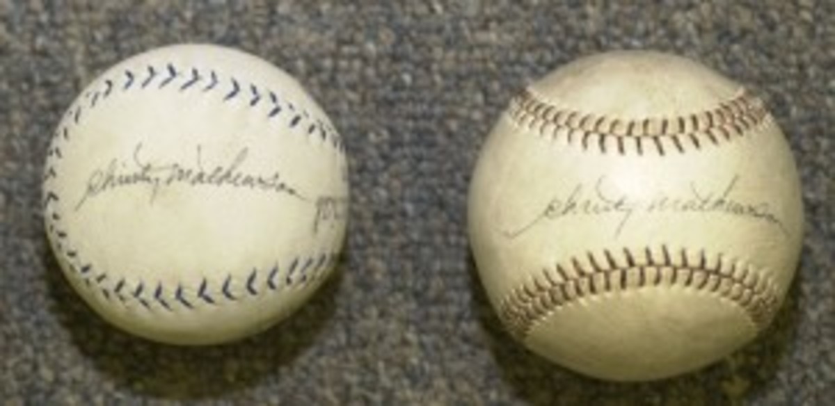Two Christy Mathewson balls: One signed on the sweet spot, one on a side panel. 
