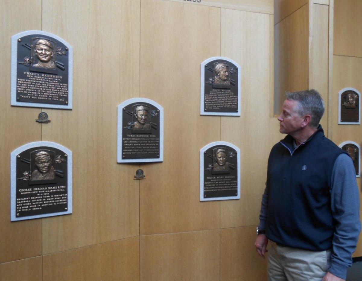 Tom Glavine admires plaques of the first five players inducted to the Baseball Hall of Fame, during a spring tour of the the shrine. The five players, counterclockwise, from top left, are Christy Mathewson, Honus Wager, Walter Johnson, Ty Cobb (in center) and Babe Ruth. Cobb is in the middle because he had the highest vote total of all first-year members. Photos by Paul Post.