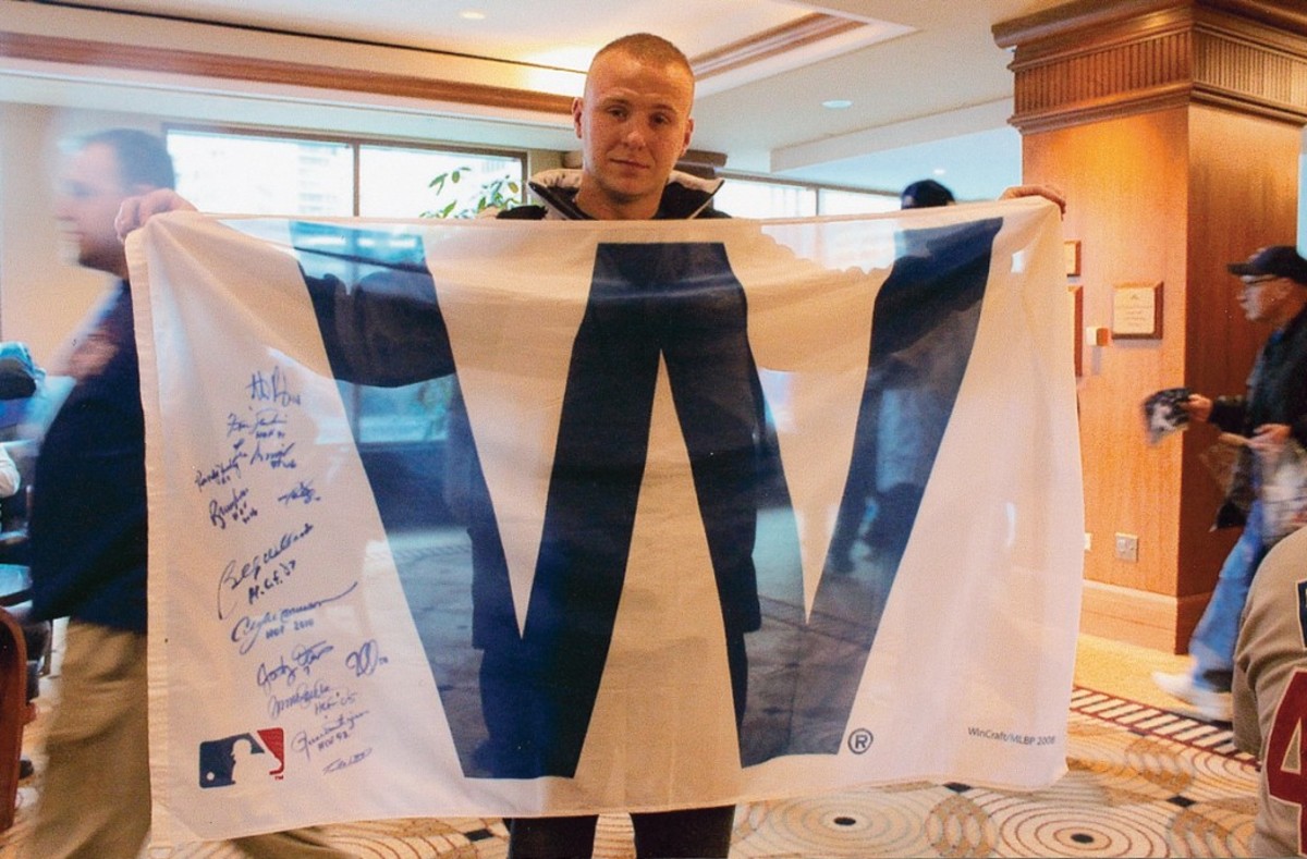 Fan Adam Zettler holds up his autographed "W" flag.