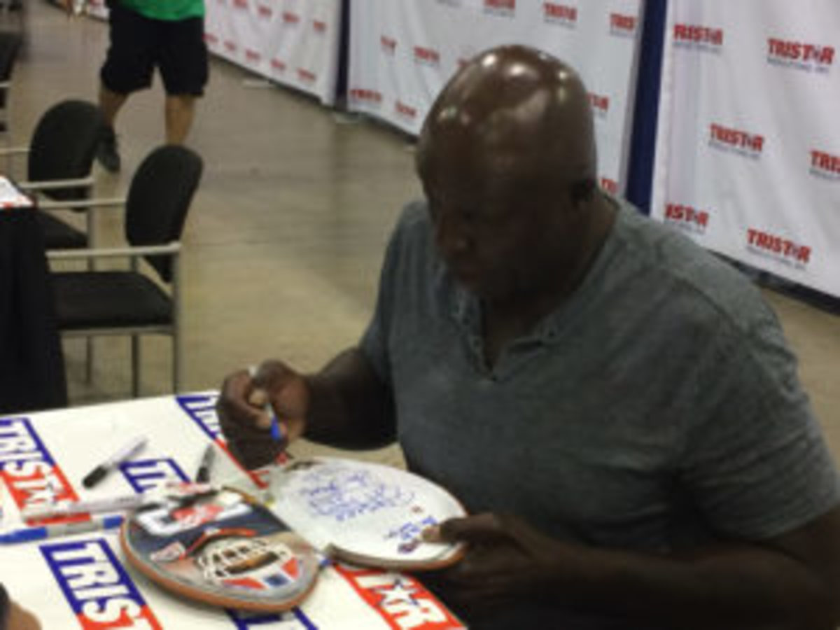  Bruce Smith signing an item for a fan at The National in Chicago in 2017.