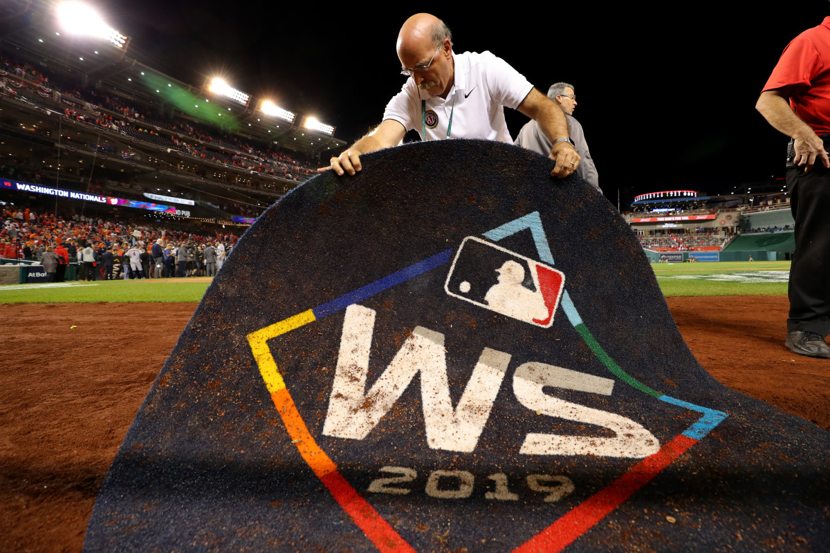 An MLB Authenticator authenticates the 2019 World Series on-deck circle with an MLB authentication sticker after Game 5 of the 2019 World Series between the Astros and Nationals. Photo: Alex Trautwig/MLB Photos via Getty Images