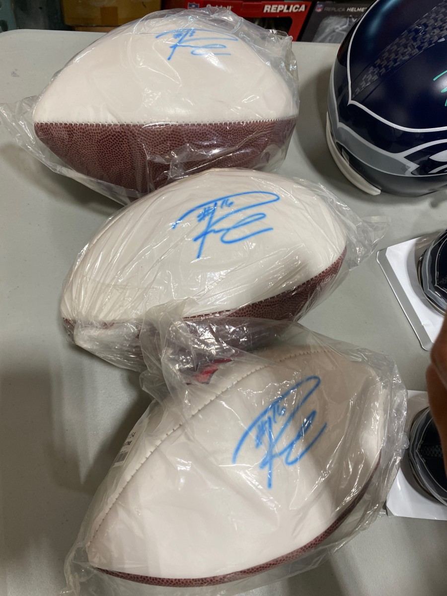 A number of footballs with fake Russell Wilson autographs that were being sold online following the Seattle Seahawks winning the Super Bowl in February 2014. Photo: Mill Creek Sports