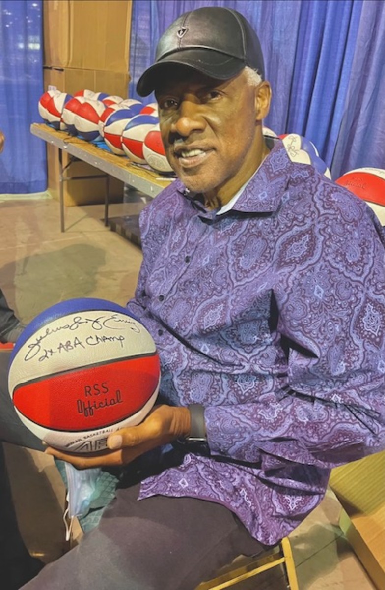 ABA and NBA great Julius Erving with a signed ABA ball being sold by Lana Sports.