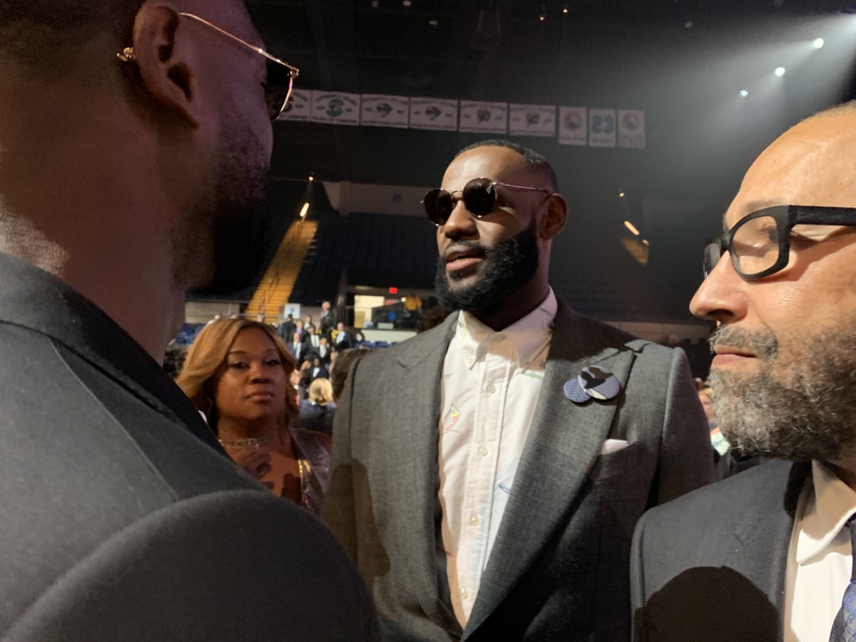 LeBron James chats with Chris Bosh at the 2021 Naismith Memorial Basketball Hall of Fame induction ceremony.