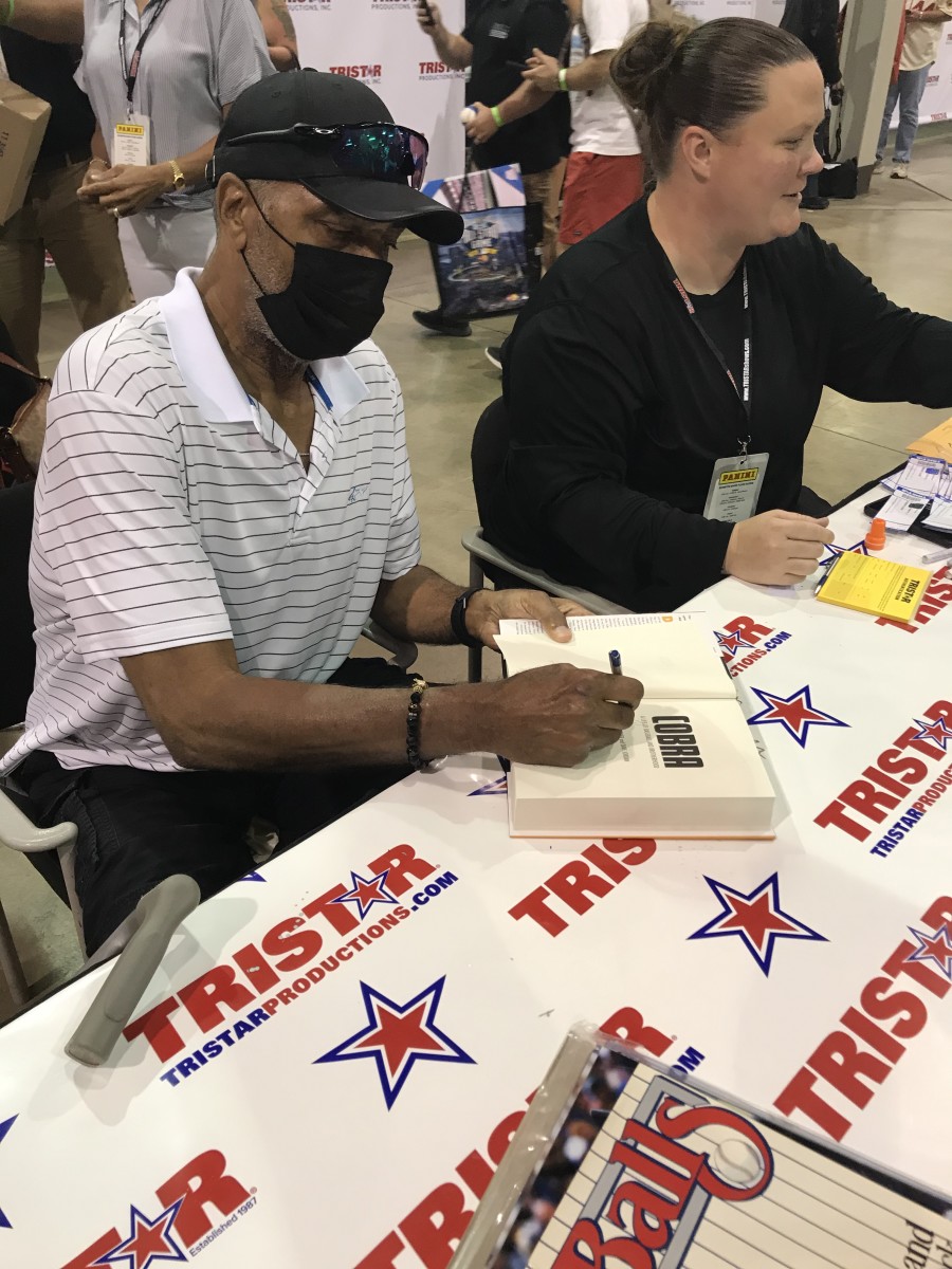 Dave Parker signs a copy of his book, "Cobra," at the 2021 National Sports Collectors Convention.