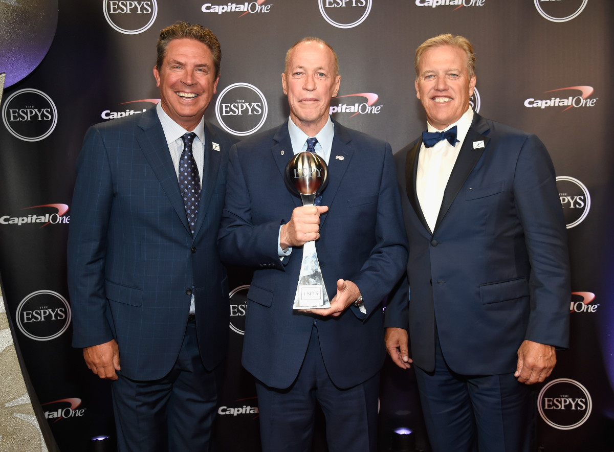 NFL legends Dan Marino (left) and John Elway (right) pose with Jim Kelly, the recipient of the Jimmy V Award for Perseverance during The 2018 ESPYS.