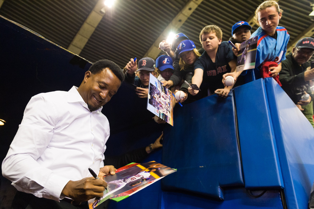 Former Montreal Expos pitcher Pedro Martinez signs autographs prior to a MLB spring training game at Olympic Stadium in Montreal in 2016.
