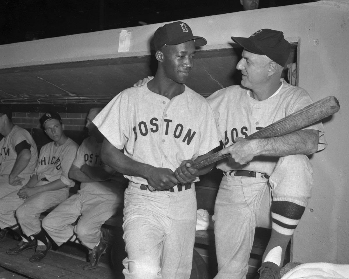 Pumpsie Green is greeted by Red Sox manager Bill Jurges prior to Green’s MLB debut in 1959. Green was the first black player to play for Boston, the last MLB team to integrate.
