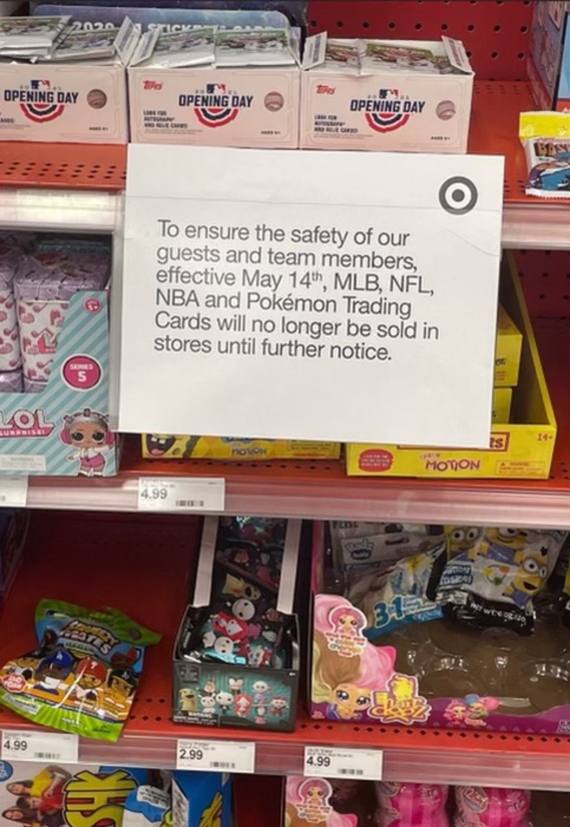 A Target sign notifies customers that the store is temporarily suspending the sale of sports and trading cards.