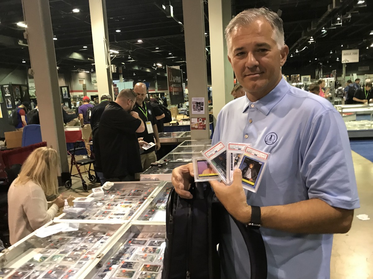 Collector Phil Hammit shows off some of the cards he picked up at The National.
