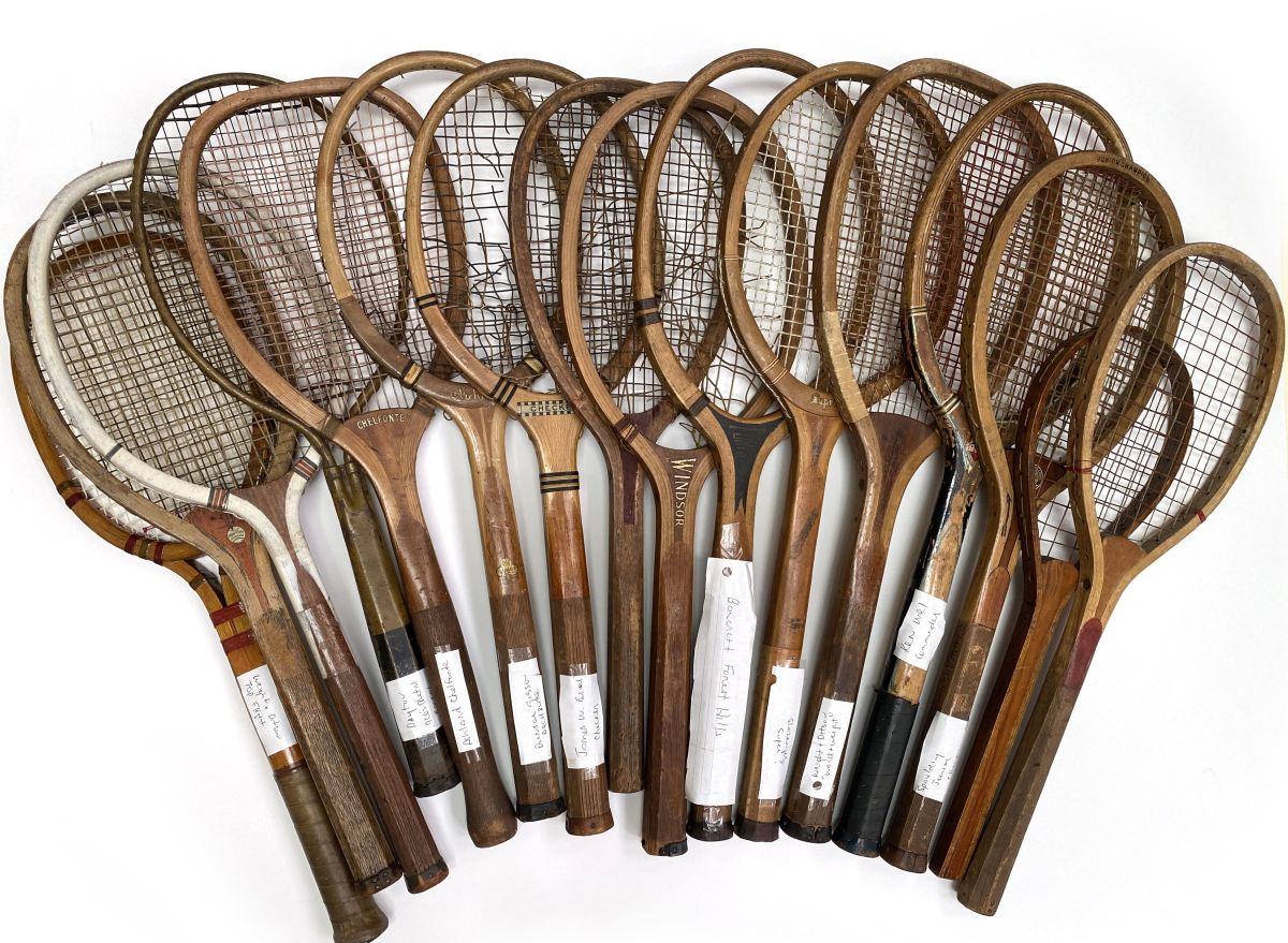 A tennis racquet collection featuring 16 vintage racquets from the late 19th century through the mid-20th century.