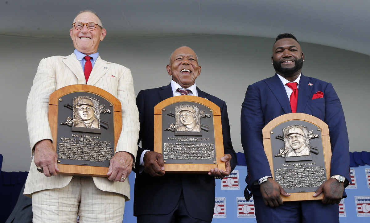 Jim Kaat, Tony Oliva and David Ortiz pose for photos during the 2022 Baseball Hall of Fame induction ceremony.