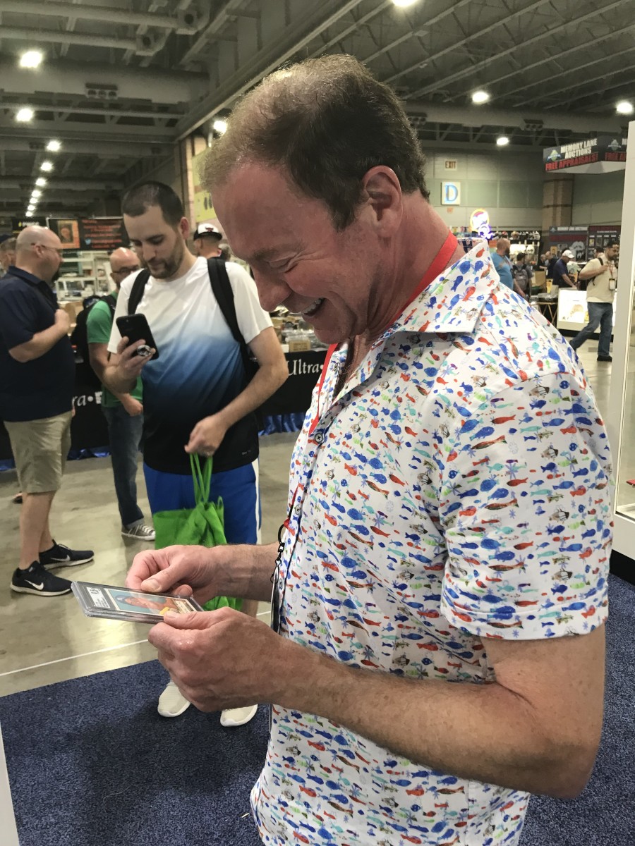 Goldin Co. Founder and CEO Ken Goldin gets a look at the 1952 Mickey Mantle card graded 9.5 at the Heritage Auction booth at The National.