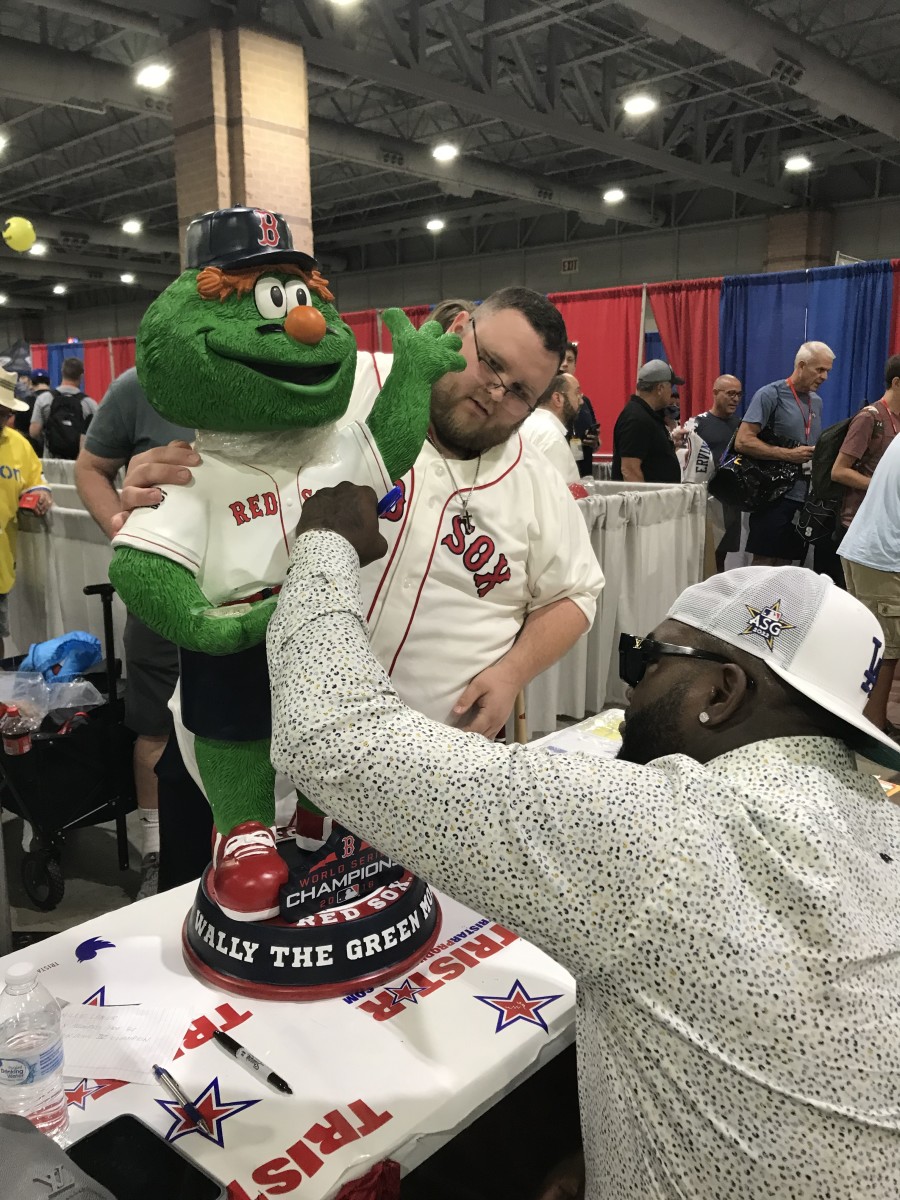 Collector Chris Brode gets his three-foot bobblehead signed by David Ortiz at The National.
