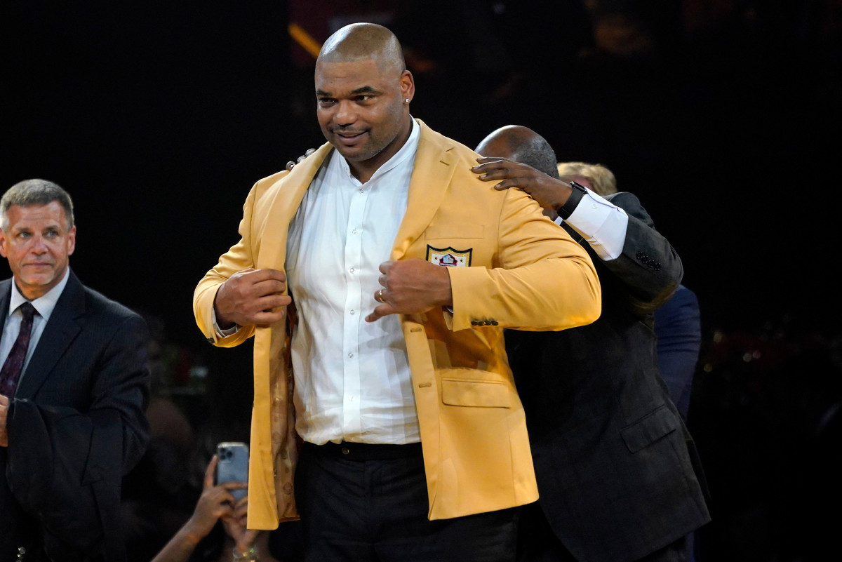 Richard Seymour dons his Pro Football Hall of Fame Gold Jacket during the 2022 induction ceremony.