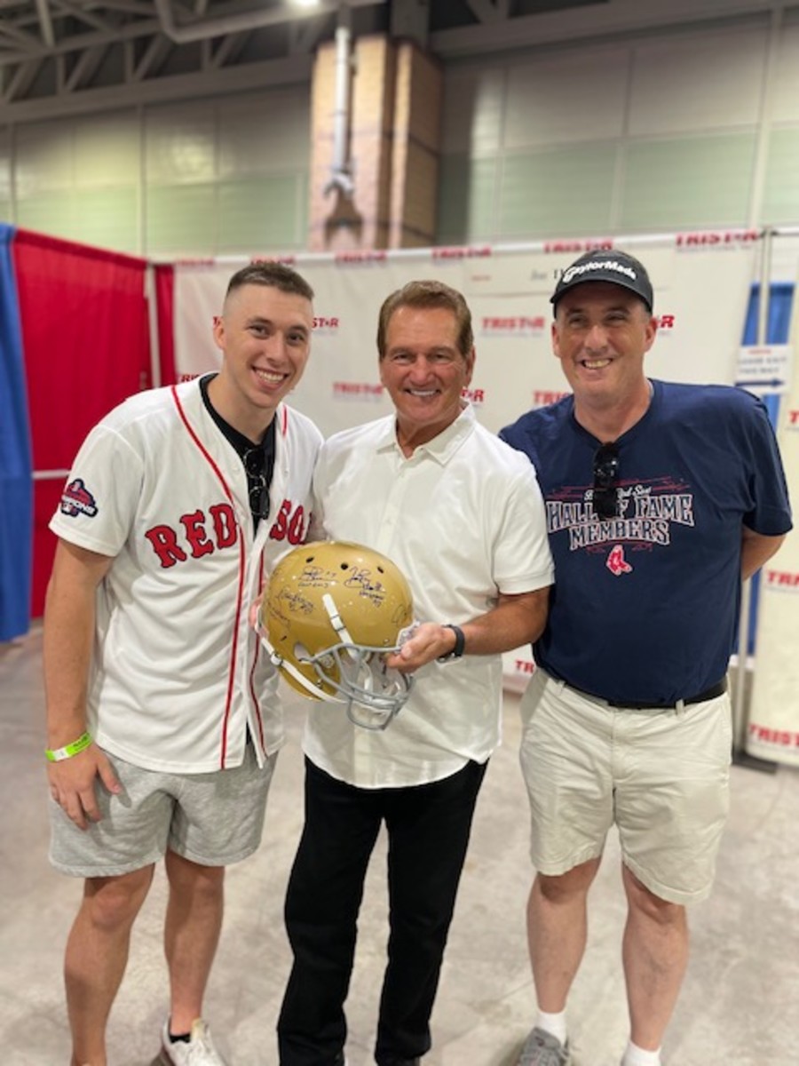 Pete and Brian Rice pose for a photo with former Notre Dame star Joe Theismann, who signed their Fighting Irish helmet.