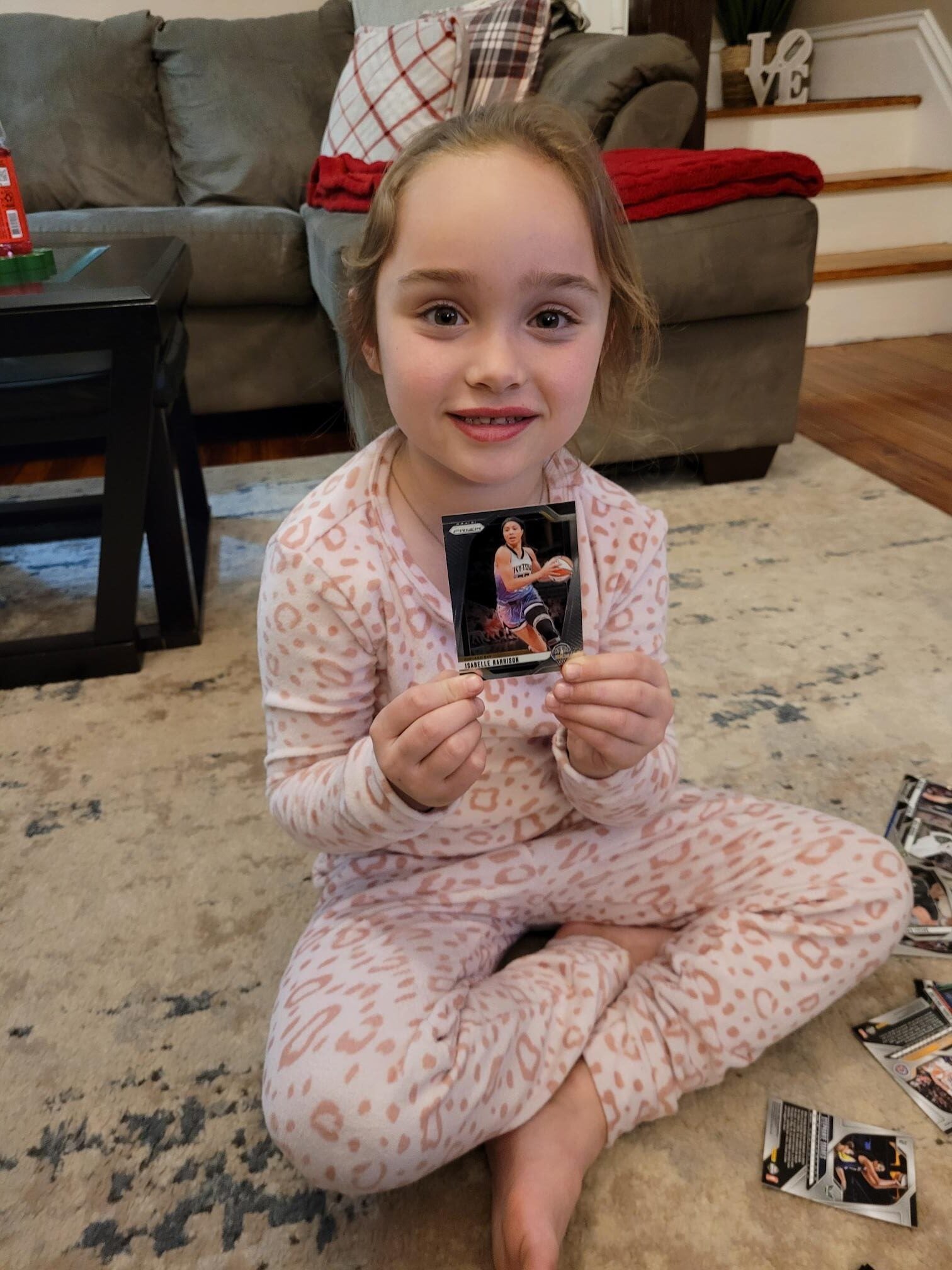 Isabella Reid pulls a Panini Prizm WNBA card of Isabelle Harrison. 