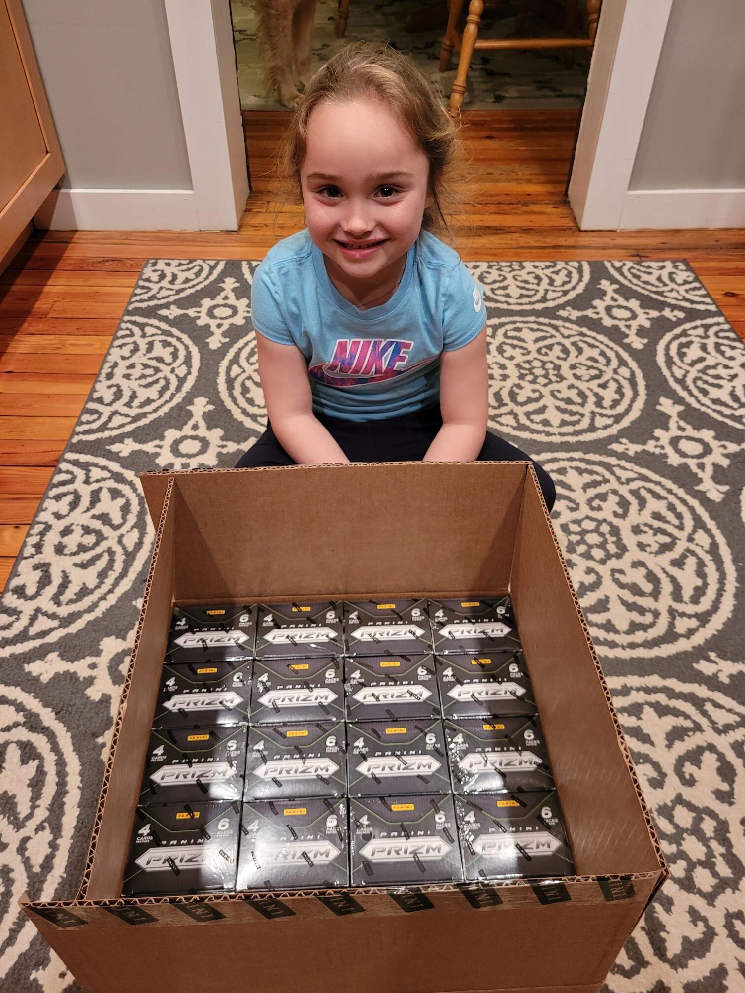 Isabella Reid with a case of Panini Prizm WNBA basketball cards. 
