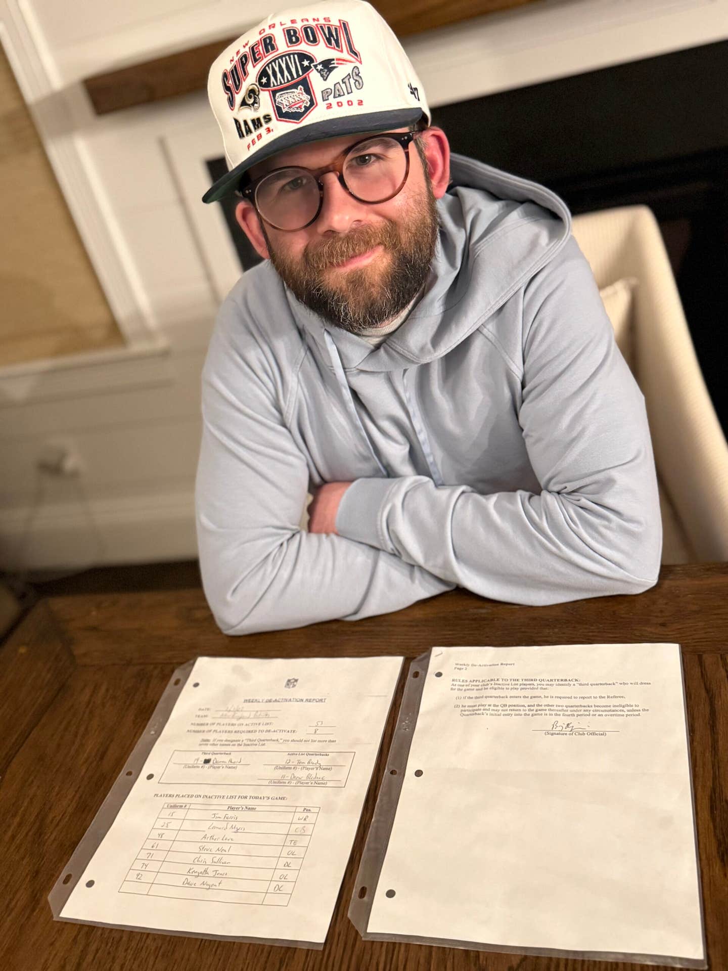 Patriots fan Matt Lavoie shows off the Patriots deactivation report from Super Bowl XXXVI, which shows Tom Brady at QB1.
