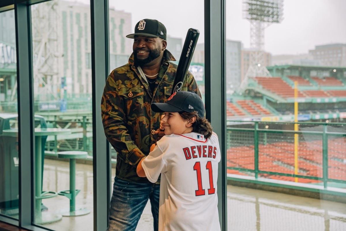 A young Red Sox fan meets baseball legend David Ortiz at the Fenway Card Show at Fenway Park in Boston. 