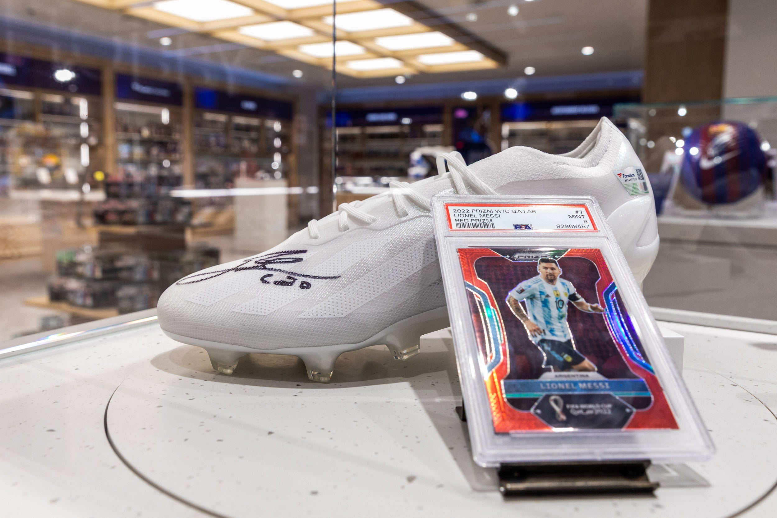 Lionel Messi trading card and cleats at the Fanatics Collectibles store in London. 