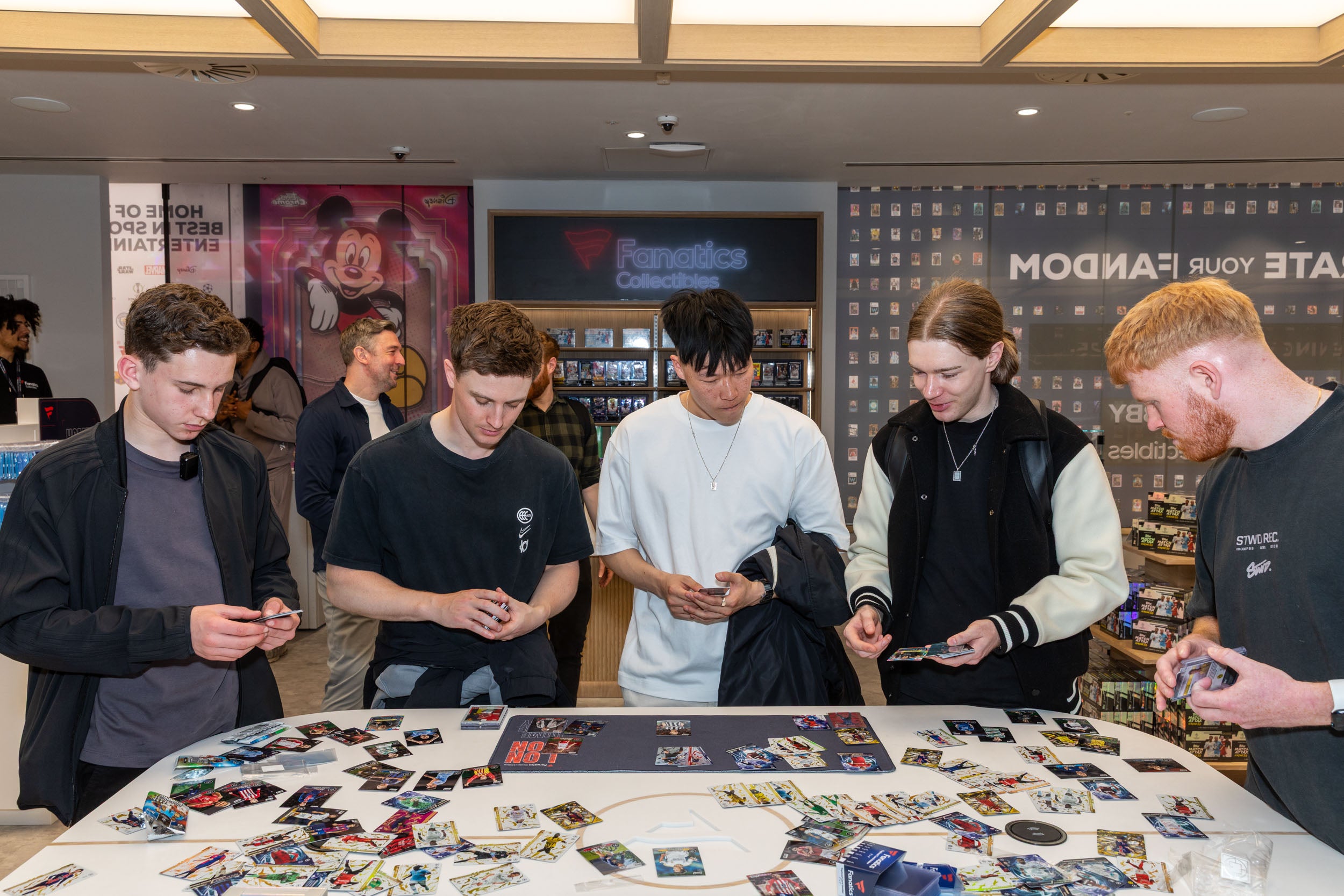 Collectors play a trading card game at the Fanatics Collectibles store in London. 