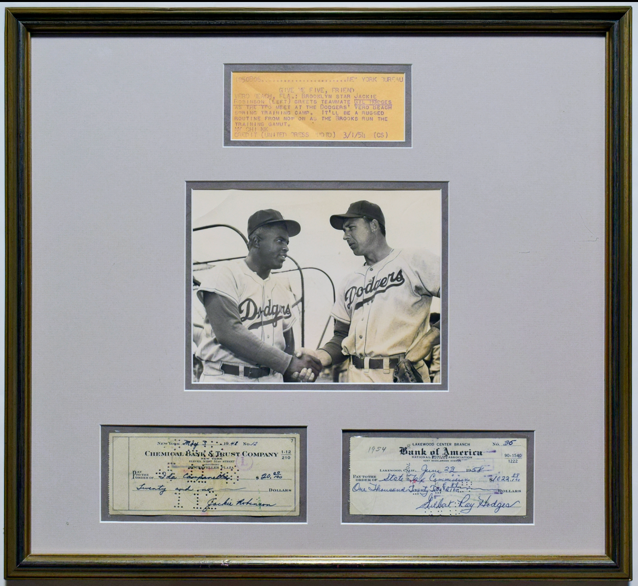 Jackie Robinson and Gil Hodges signed checks. 