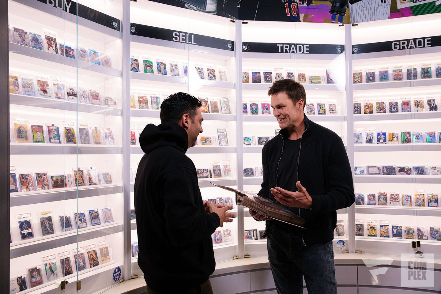 Tom Brady shows his baseball card binder to “Card Shopping” host Joe La Puma.