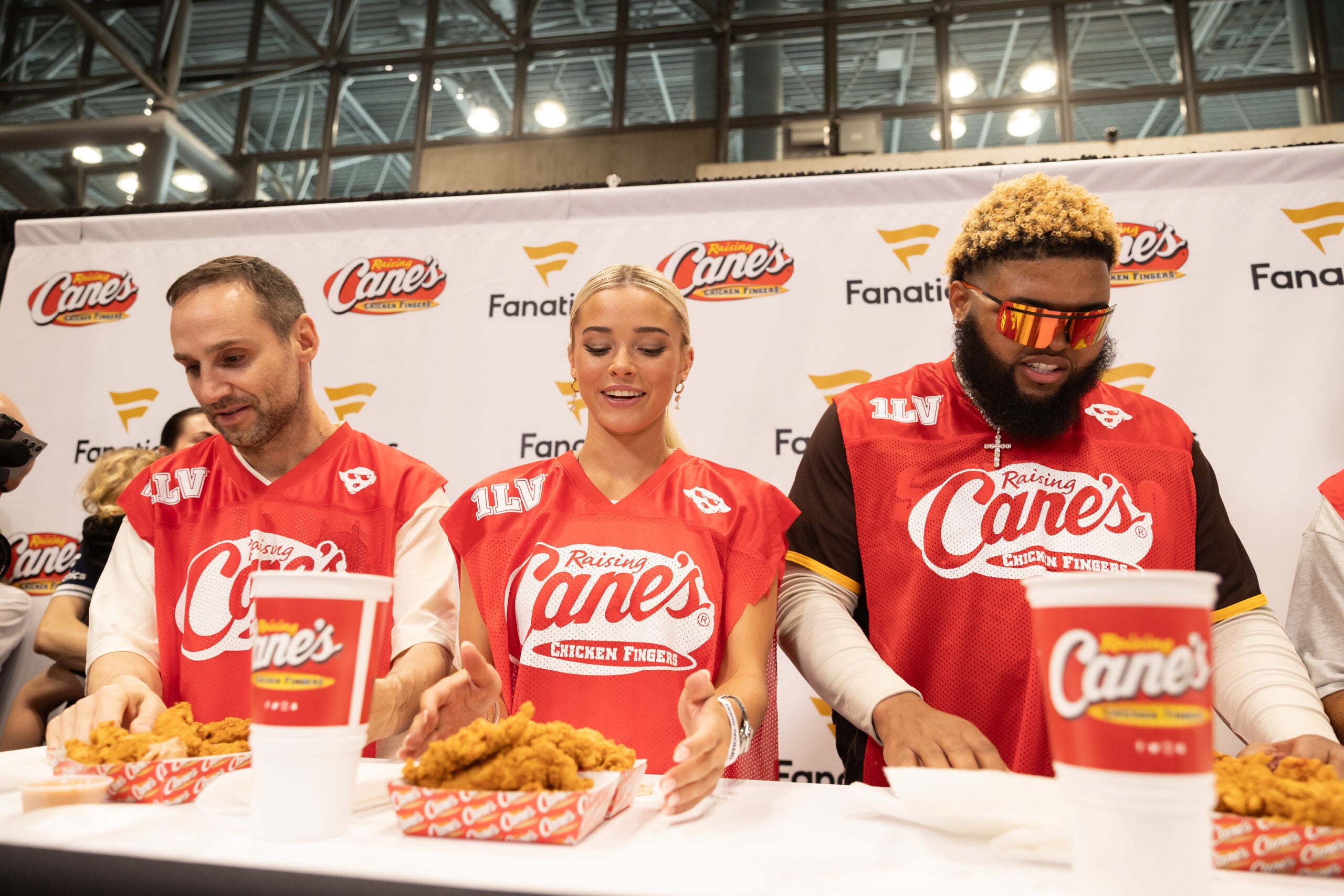 Rubin, Livvy Dunne and Druski at the Raising Cane's chicken-finger eating contest at Fanatics Fest NYC. 