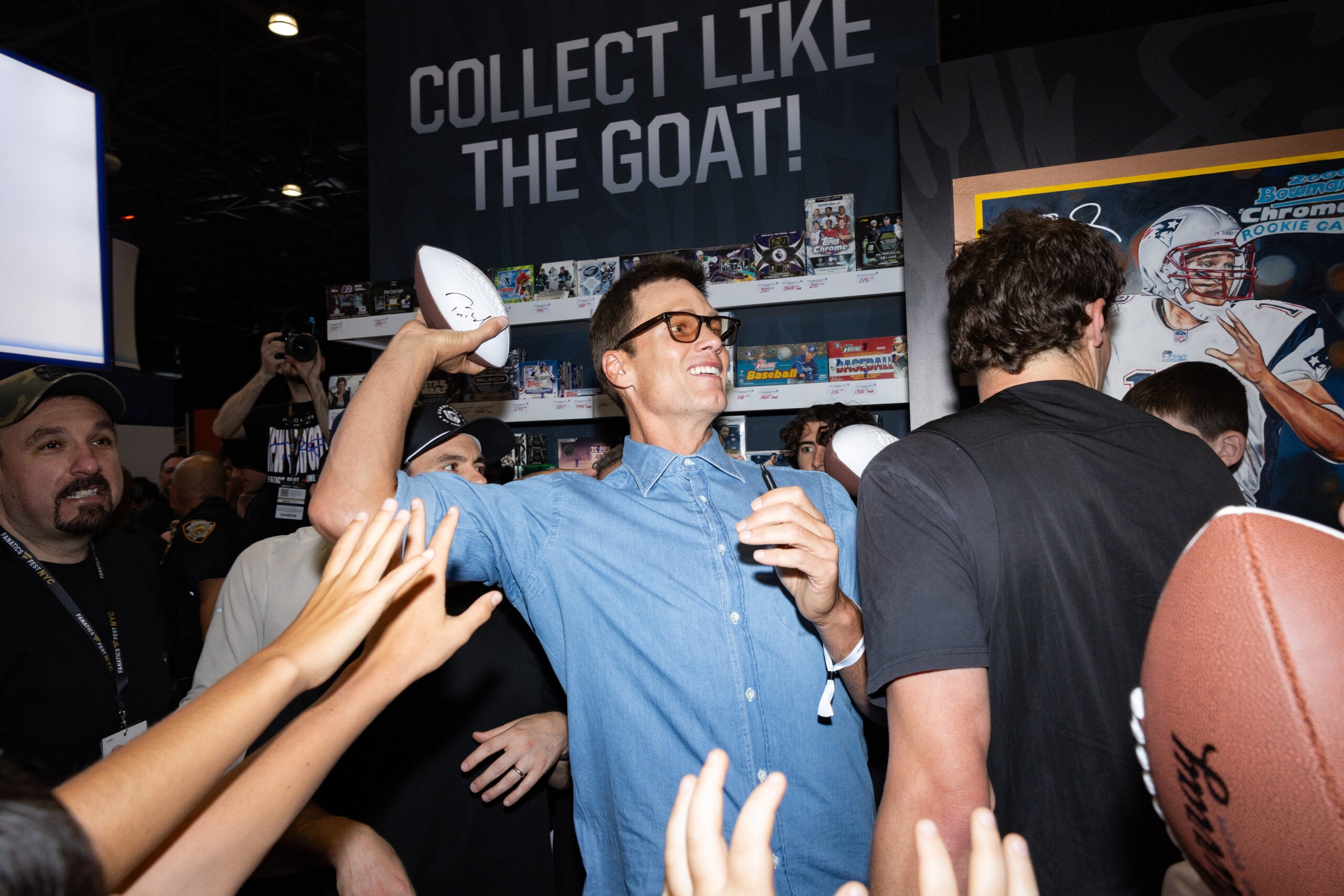 Tom Brady tosses a football to fans at Fanatics Fest NYC. 