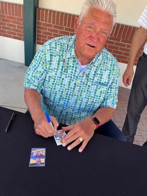 Clint Hurdle signs trading cards at Pirates spring training. 