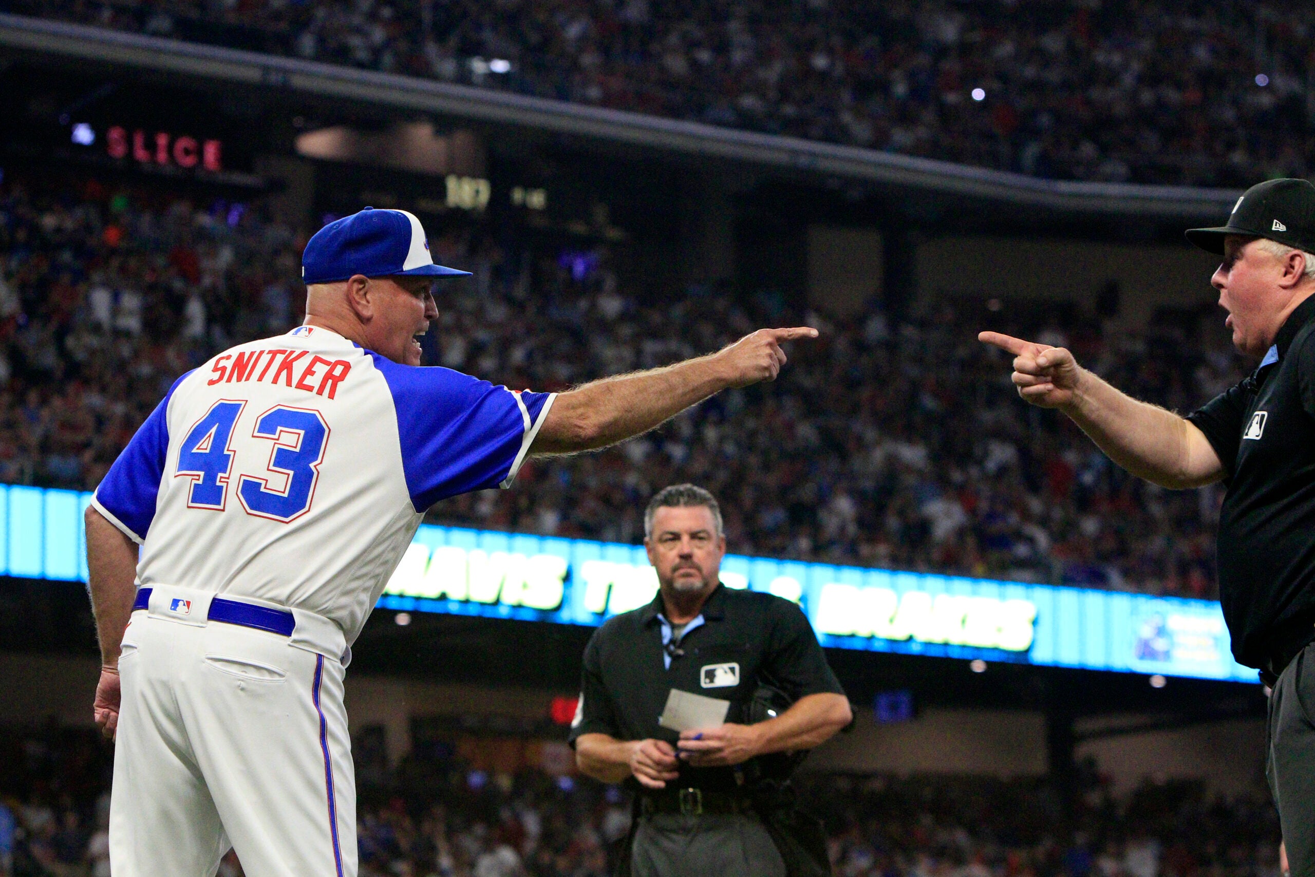 Braves manager Brian Snitker argues with umpire Bill Miller at Truist Park in Atlanta in 2023. 