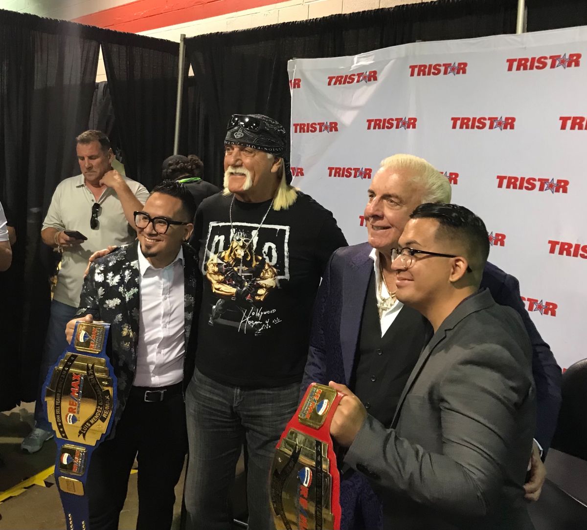 Hulk Hogan and Ric Flair pose for photos with fans at the 2021 National Sports Collectors Convention. 