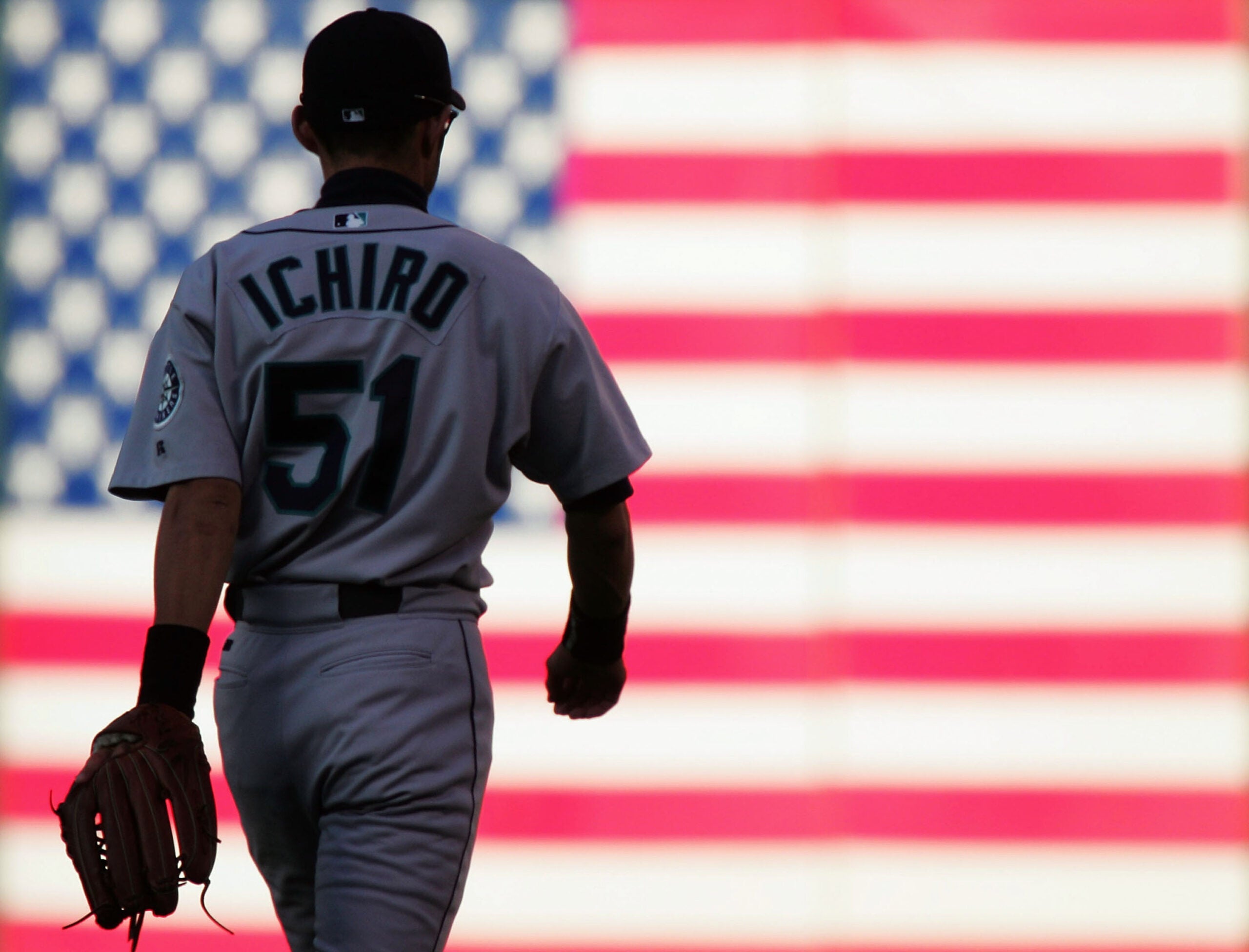 Ichiro Suzuki walks to right field for the Seattle Mariners at Network Associates Coliseum in Oakland in 2004. Ichiro moved from Japan to the U.S. and the major leagues in 2001. 