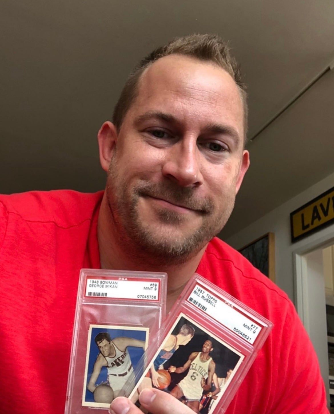 Collector Jason Koonce shows off vintage gems of George Mikan and Bill Russell. 